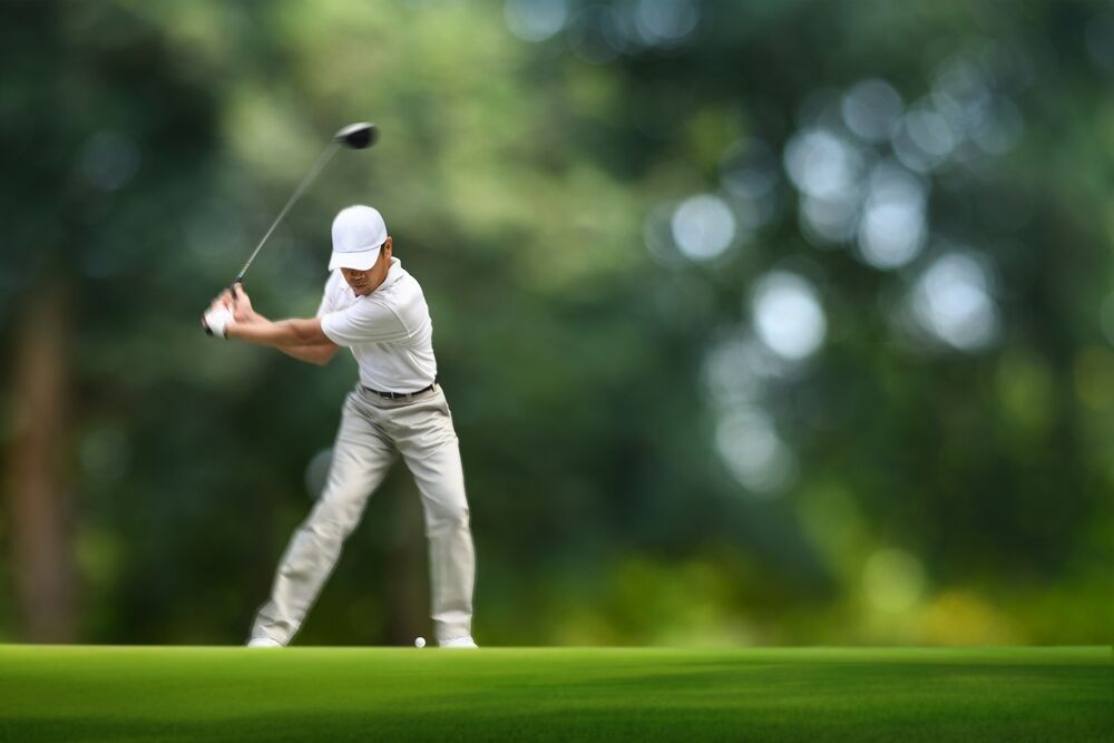 Golfer showing shaft flex on his downswing