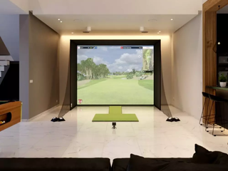 Golf room with a home golf simulator