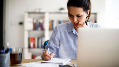 academic writing at desk by woman