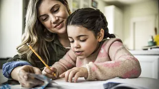 Child and mother working on spelling list