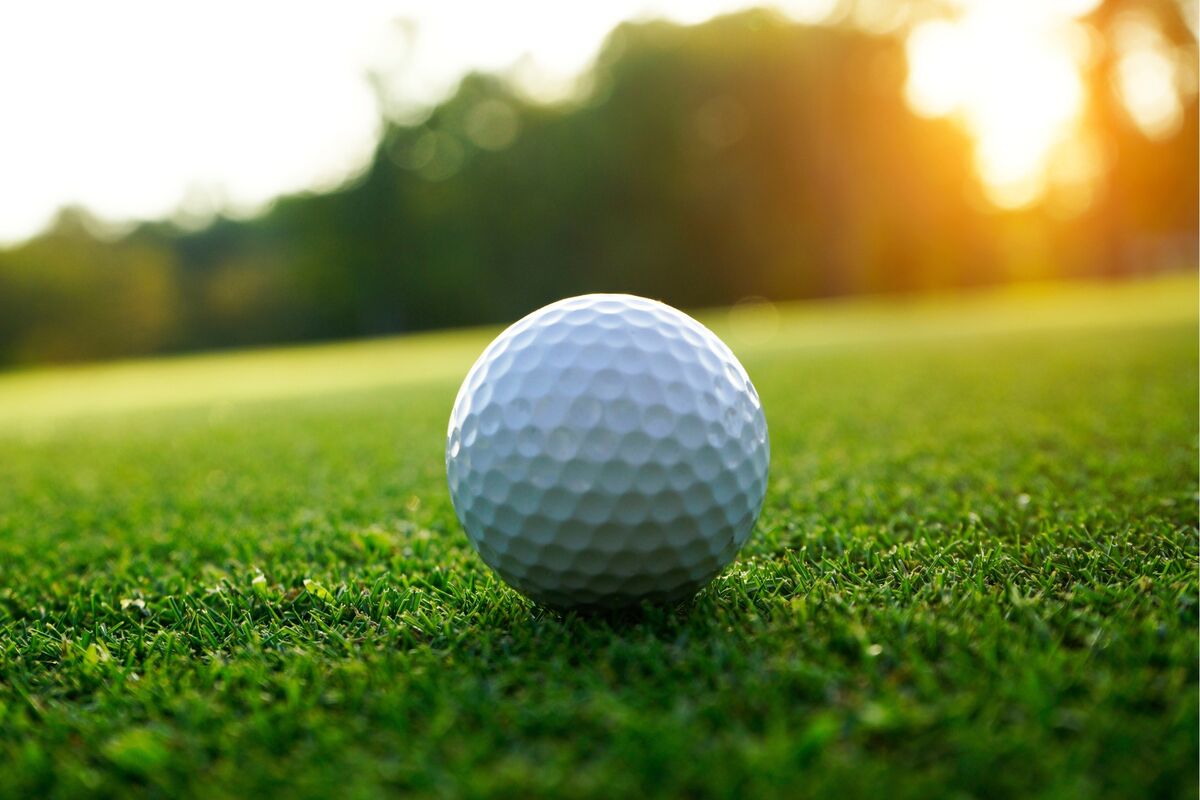 golf balls up close with green background