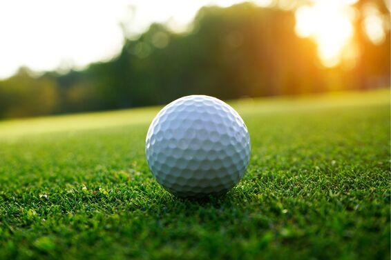 golf balls up close with green background