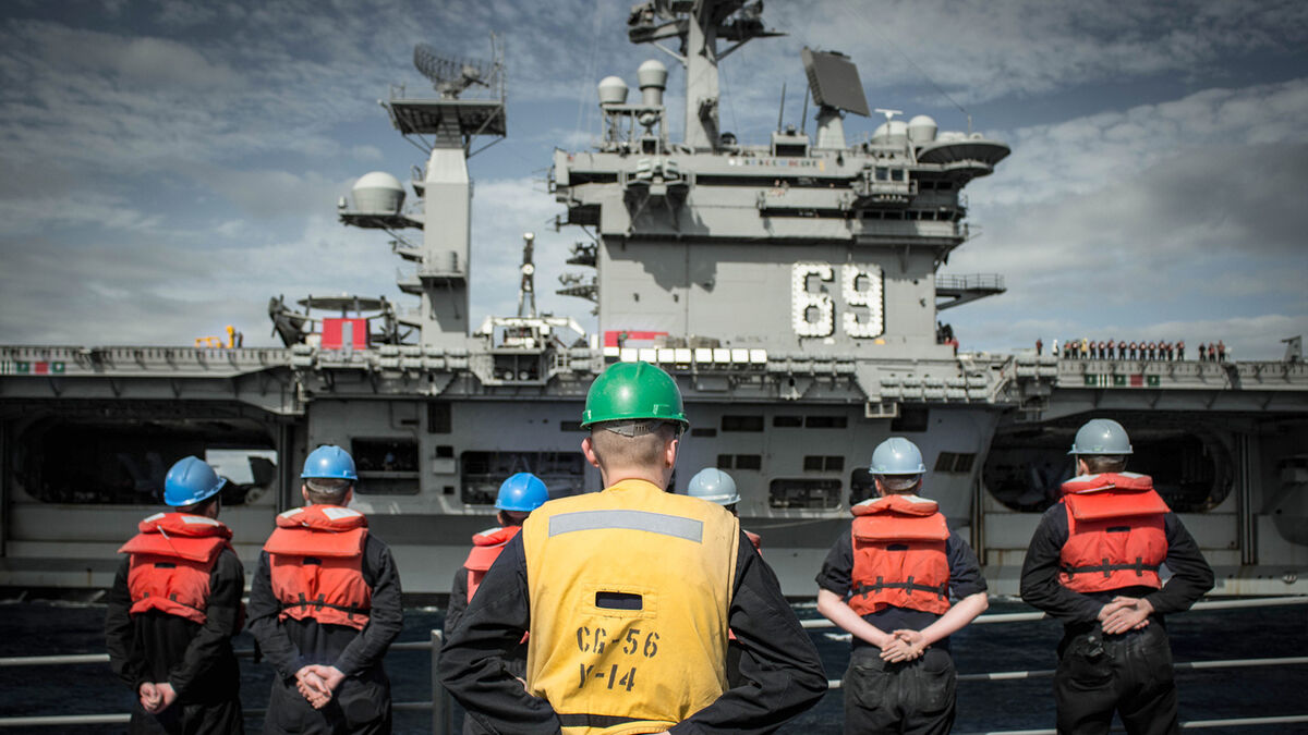 navy soldiers standing against ship