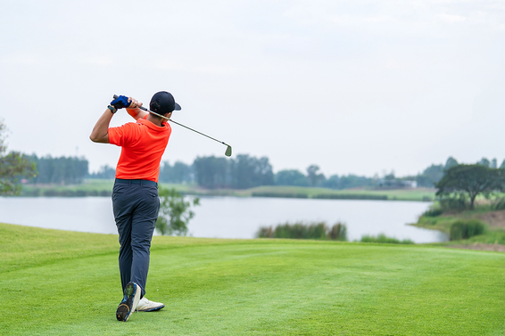 Golfer holds his finish after a golf swing