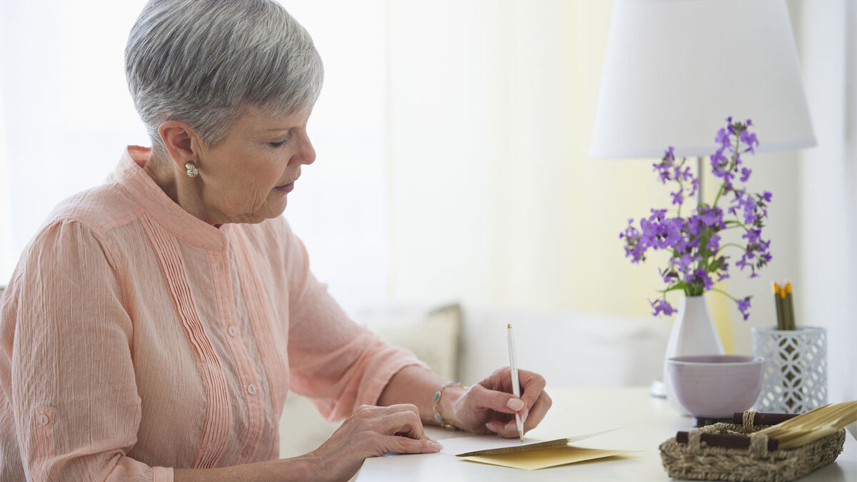 woman writing sympathy card