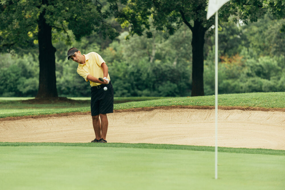 Golfer trying to get up and down.
