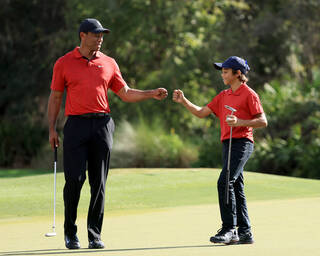 Tiger and Charlie Woods fist bump