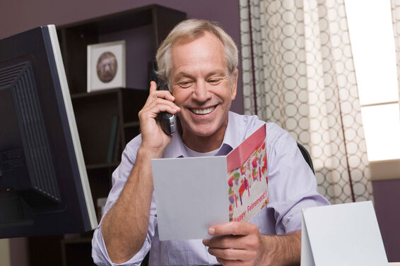 man reading funny retirement card in office