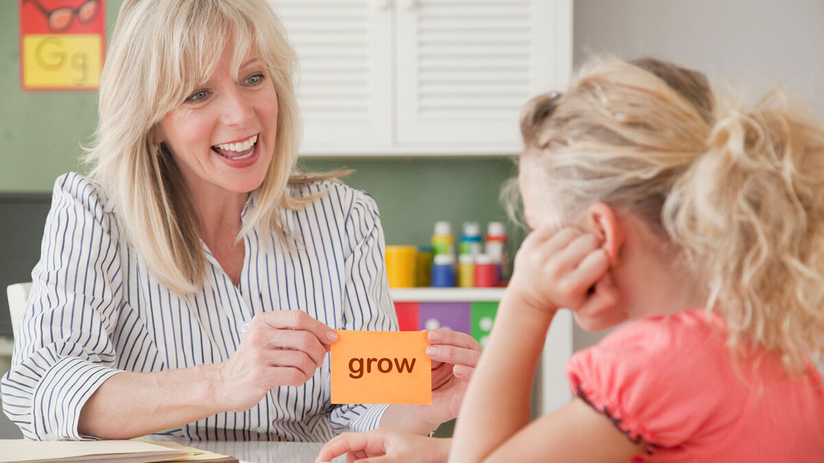 Teacher holding up grow flash card