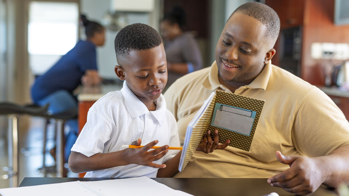 Father helping son with reading