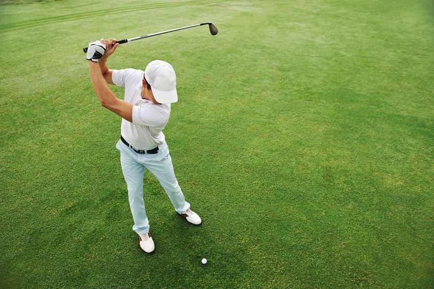 golfer at the top of backswing