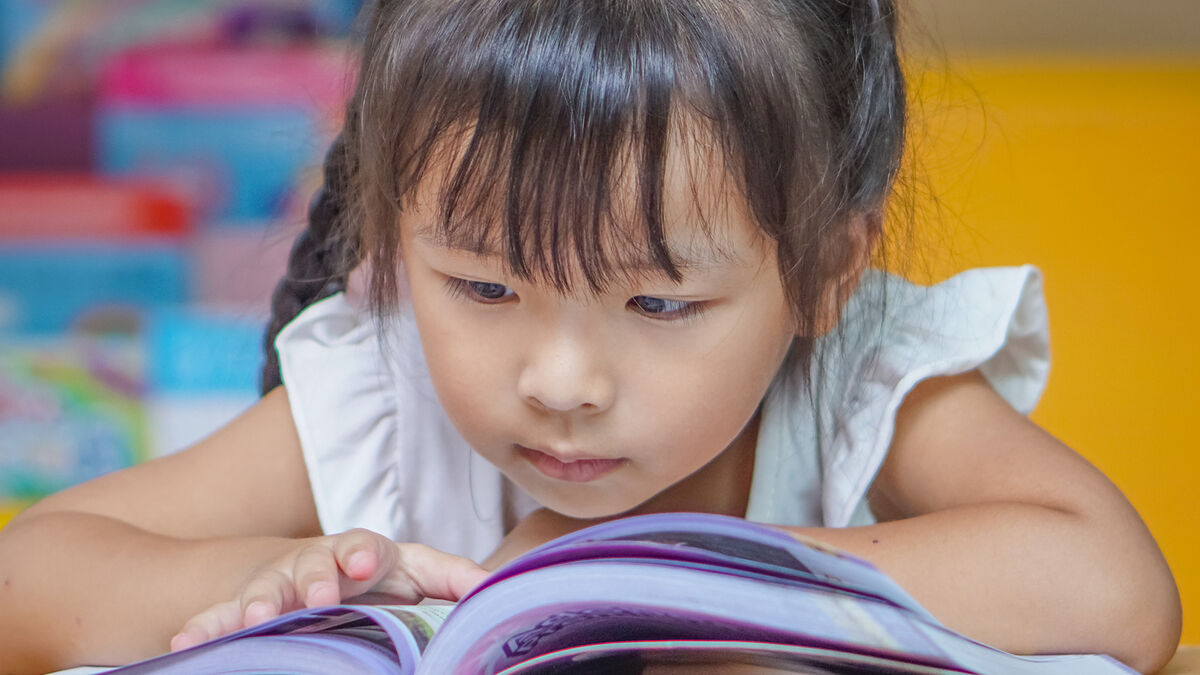 Kindergartener reading book