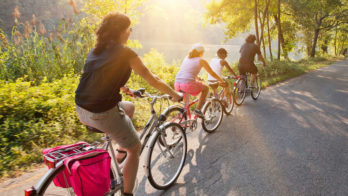 people riding bikes on country road