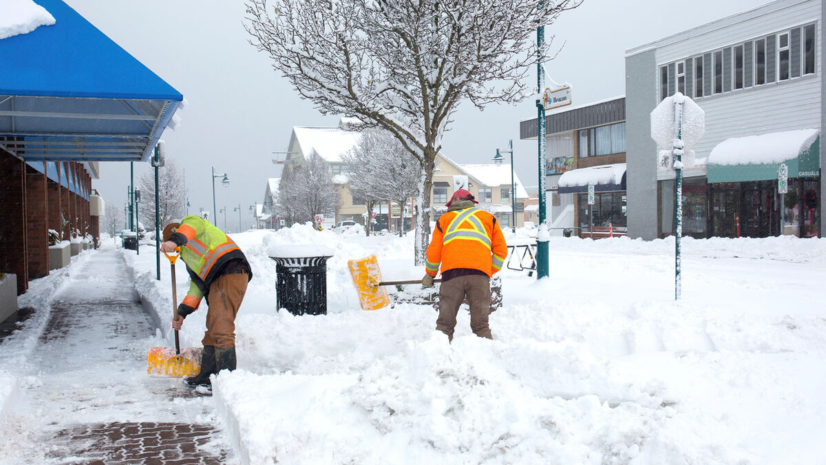 workers shoveling snow from winter storm