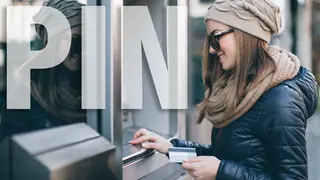 Woman entering PIN at an ATM