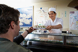 Man getting sushi as examples of cultural diffusion