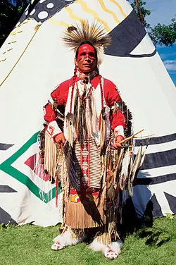Native American in front of teepee as examples of genocide