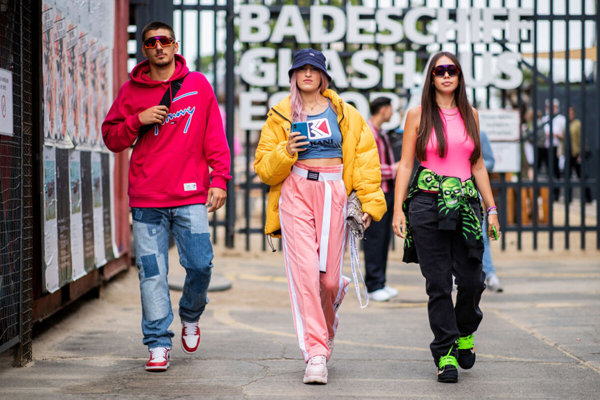 Three people wearing trendy fashion brands
