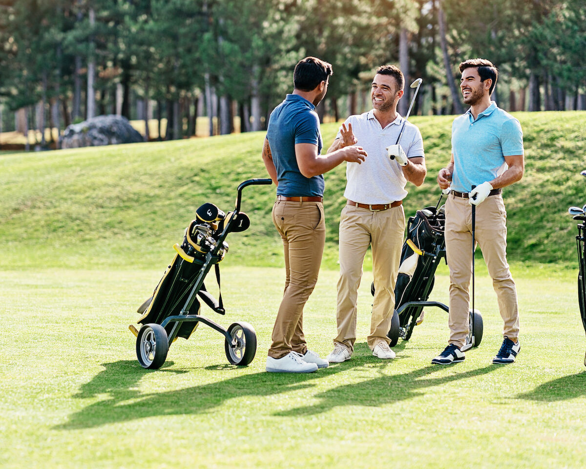 Three golfers having fun on course