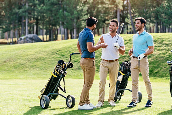 Three golfers having fun on course