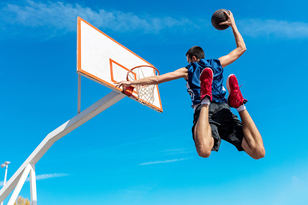 Basketball street player making slam dunk