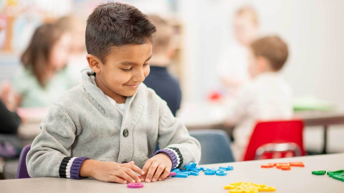 first grade boy practicing letters