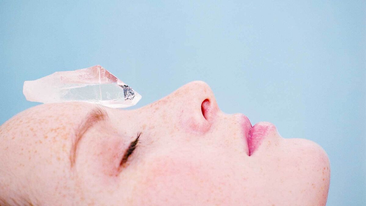 woman receiving crystal healing as examples of skepticism