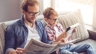 father and son comparing facts opinions reading newspaper