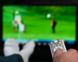 Man watching golf on tv