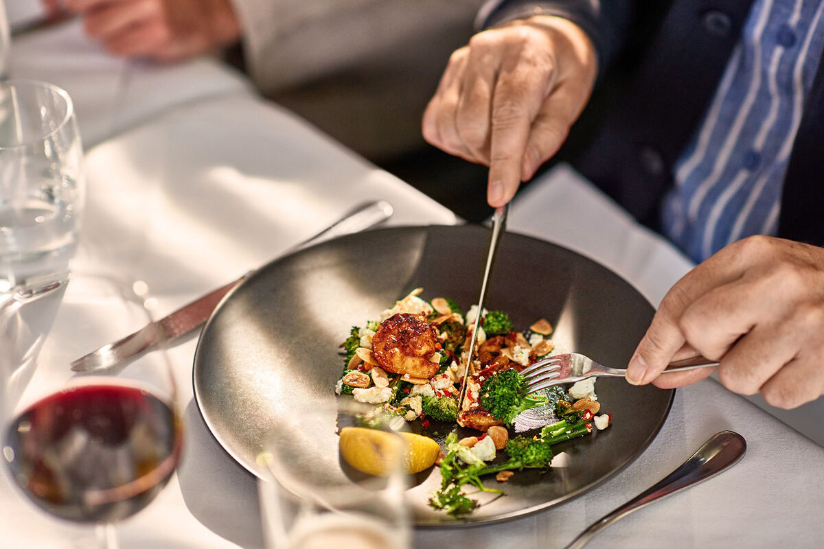 Man eating freshly prepared meal in restaurant