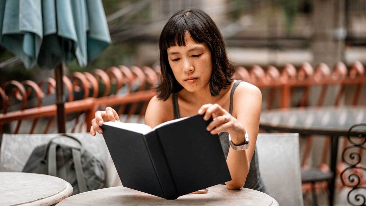 woman reading tagalog poem in an outdoor cafe