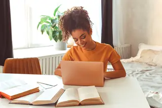 Woman Using Laptop At Home