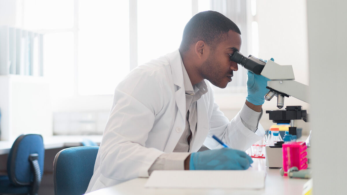 scientist observing through a microscope