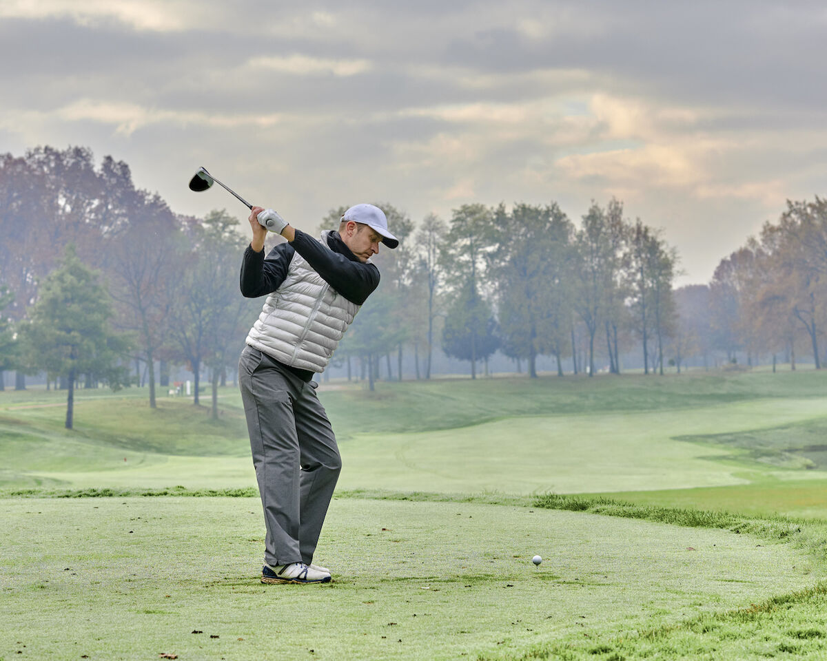 Golfer's backswing on tee box