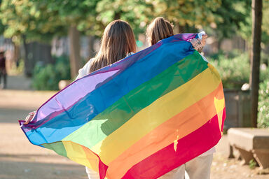 Lesbian couple holding rainbow flag