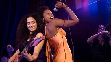 women performing music on stage