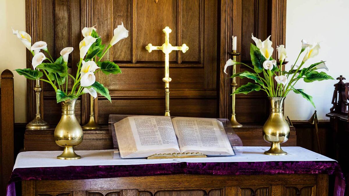 easter lilies in church with cross