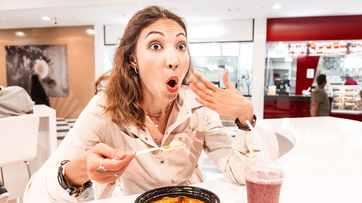 woman having spicy food reaction of burning mouth