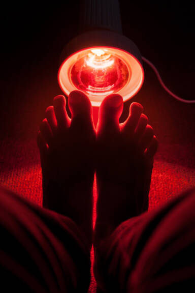 Feet glowing in red light as examples of radiation Feet glowing in red light as examples of radiation