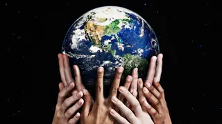 hands holding up planet
