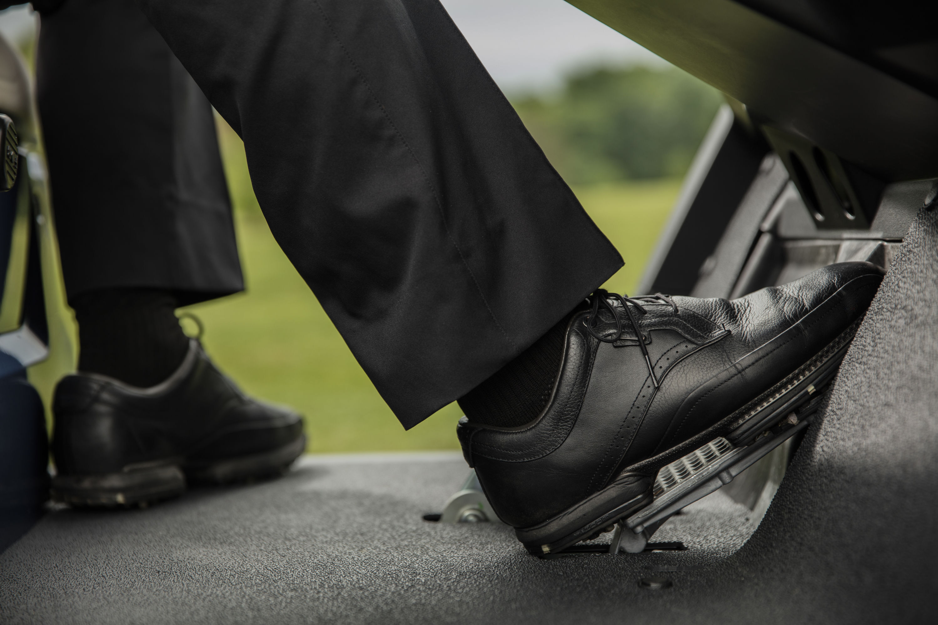 Golfer's foot on golf cart accelerator