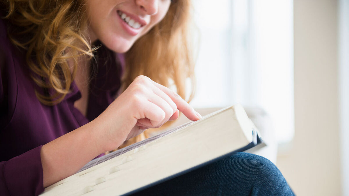 woman checking her vocabulary in dictionary