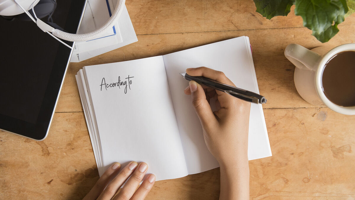 Woman writing a signal phrase for a story