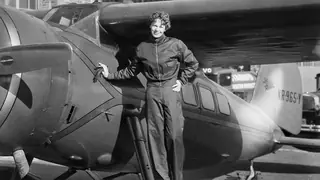 Amelia Earhart next to aircraft