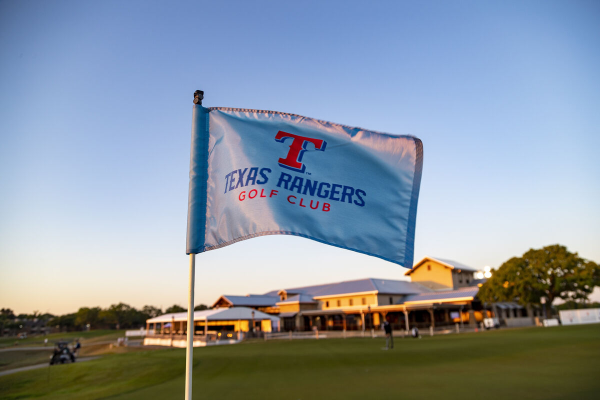 Pin flag at Texas Rangers Golf Club with the clubhouse in the background