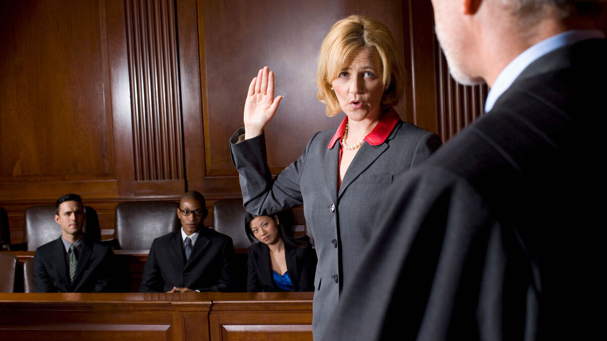 woman taking oath in courtroom