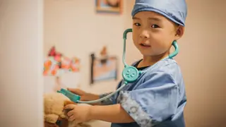 observational learning toddler boy playing doctor