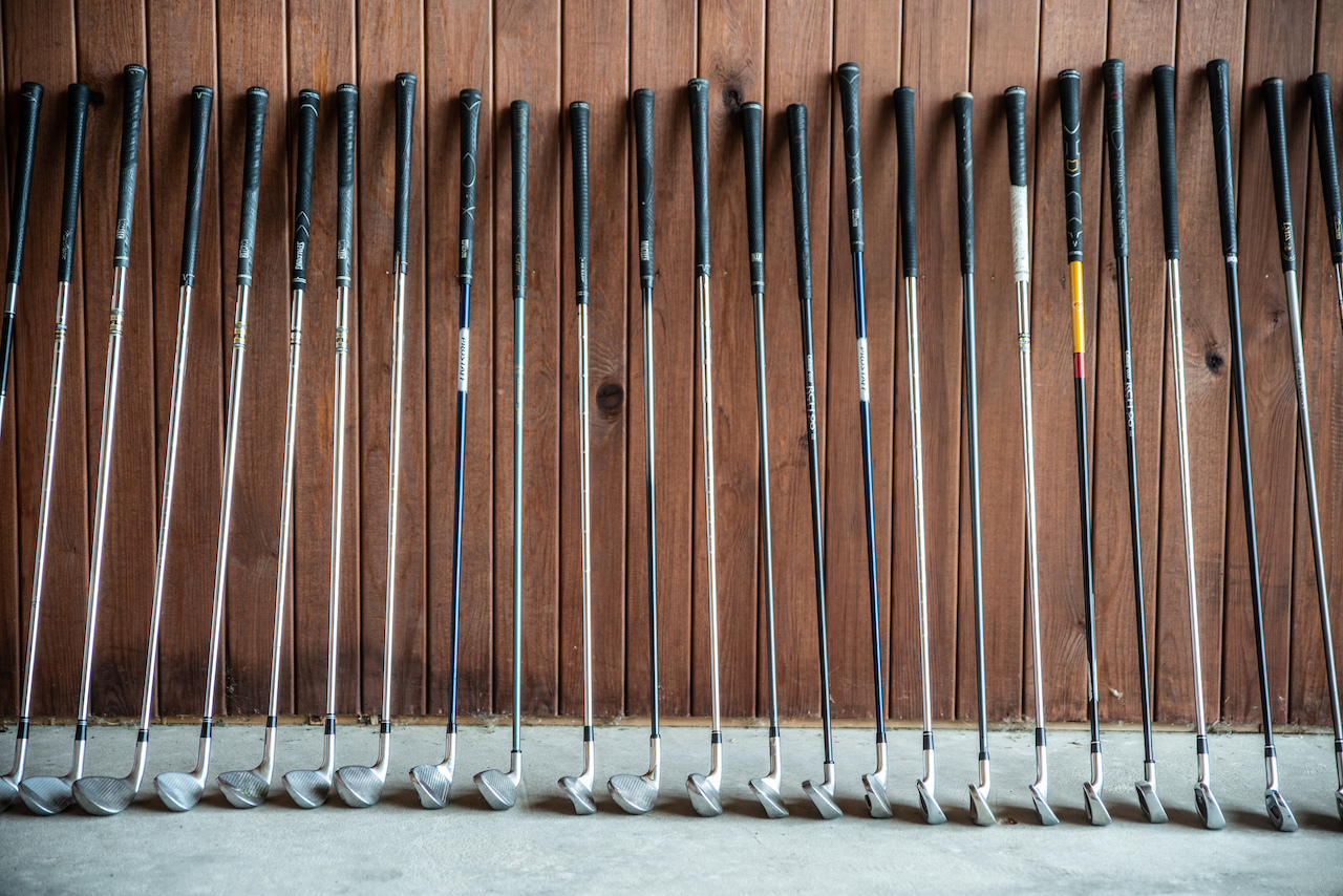 golf clubs with wood background