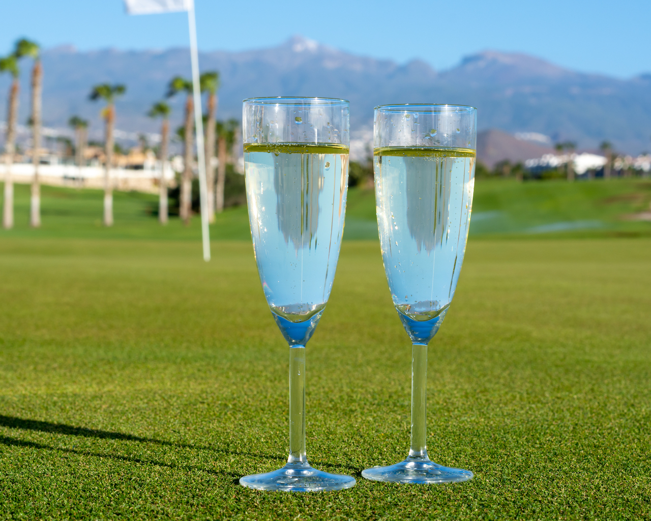 champagne glasses on golf putting green
