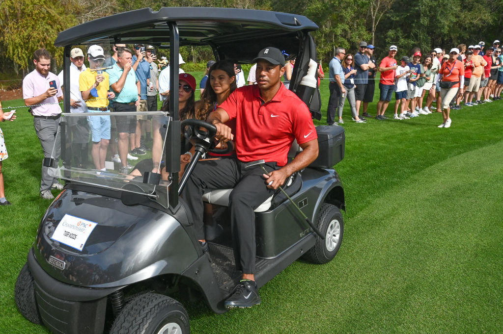Tiger Woods rides in a golf cart